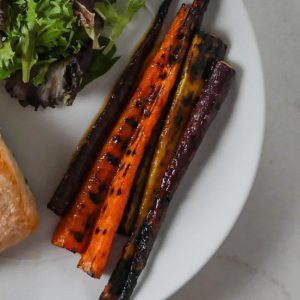 grilled carrots on a white plate