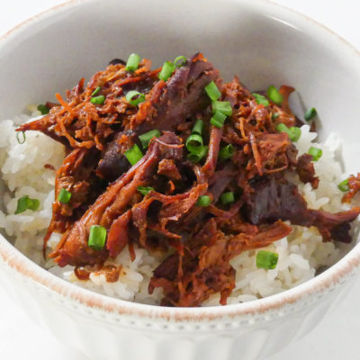 Chicken thighs with hoisin sauce over sticky rice