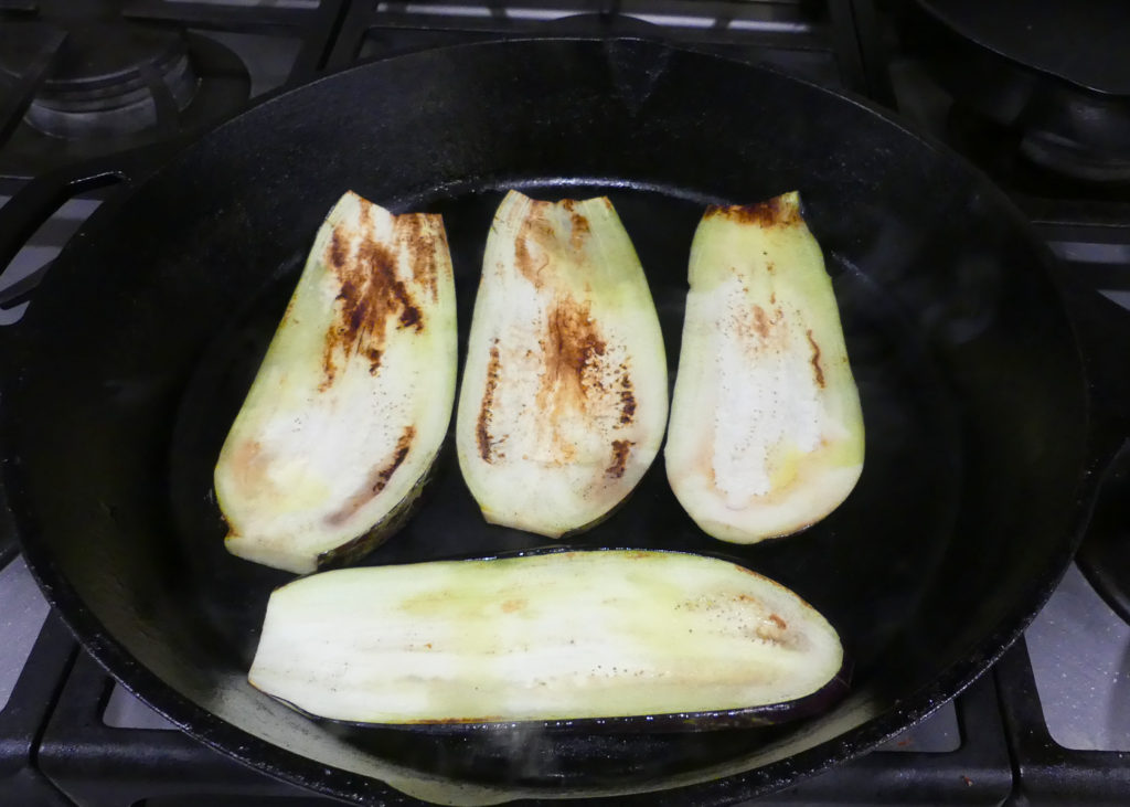 grilled eggplant in a cast iron skillet