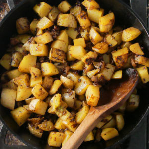 golden potatoes in a cast iron skillet